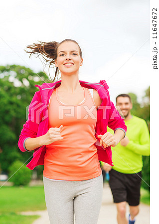 smiling couple running outdoors smiling couple running outdoors 11647672