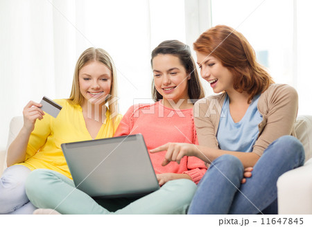 smiling teenage girls with laptop and credit card smiling teenage girls with laptop and credit card 11647845