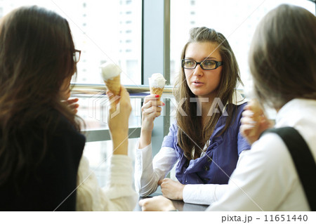 happy women licking ice cream happy women licking ice cream 11651440