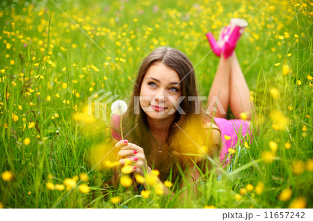 woman blow on dandelion 11657242
