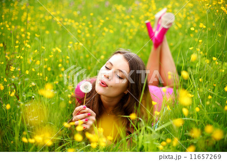 woman blow on dandelion 11657269
