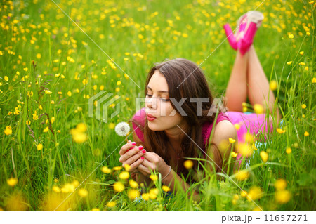 woman blow on dandelion 11657271