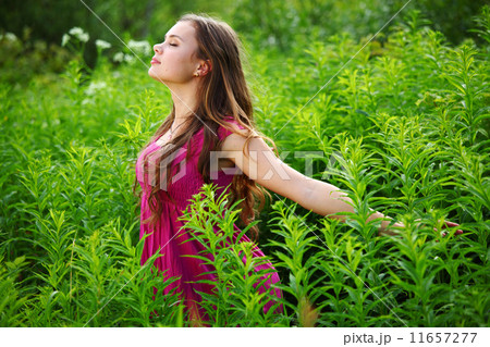 woman on green grass field 11657277