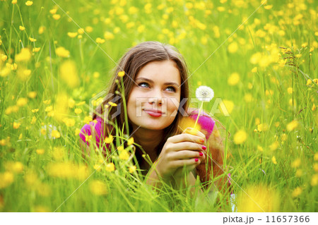 woman blow on dandelion 11657366