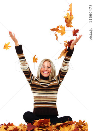 woman drop autumn leaves in studio woman drop autumn leaves in studio 11660478