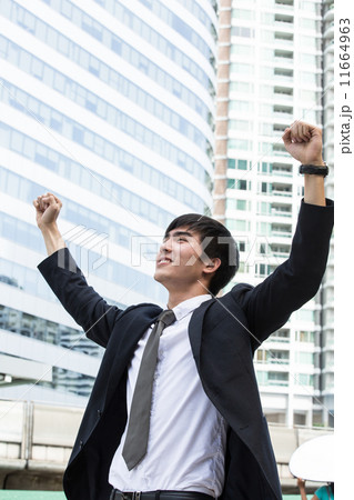 Asian businessman hand up after successful 11664963