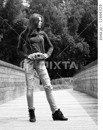 Young woman photographer outdoors 11666329
