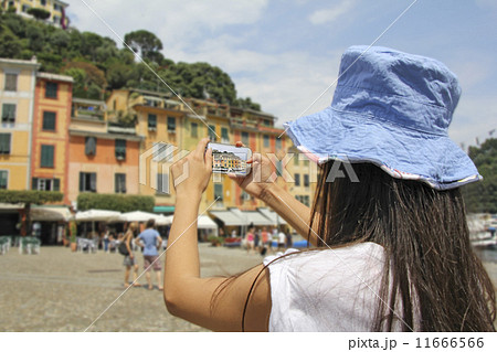 Portofino, Woman photographing with mobile phone 11666566