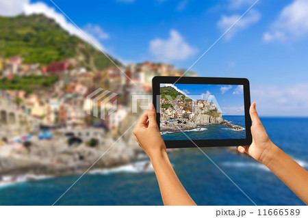 Girl taking pictures on a tablet in Manorola Girl taking pictures on a tablet in Manorola 11666589