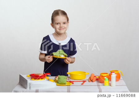 Five year old girl a plate with dish 11669088