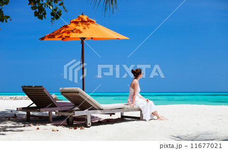 Young woman relaxing at beach Young woman relaxing at beach 11677021