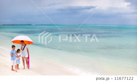 Family at beach on rainy day 11677122
