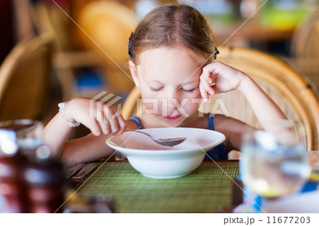 Little girl eating breakfast 11677203