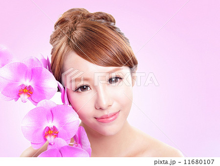 woman smile face with orchid flowers 11680107