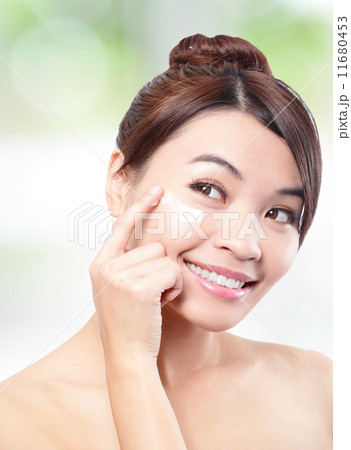 Beauty young woman applying cosmetic cream 11680453