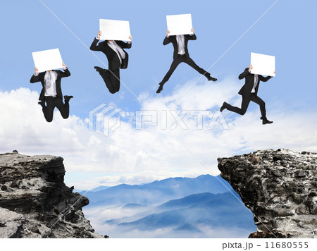 businessman jumping with billboard on the mountain 11680555