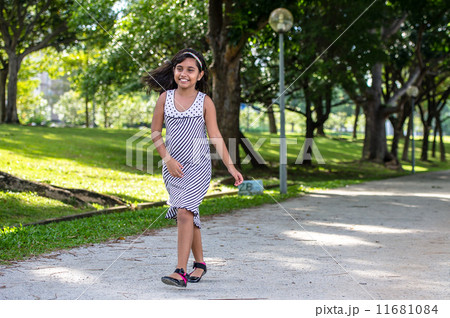 Smiling Young asian girl walking and hopping in the park Smiling Young asian girl walking and hopping in the park 11681084