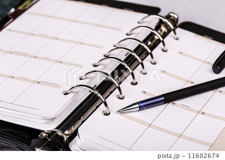 Personal organizer or planner with pen on white background 11682674