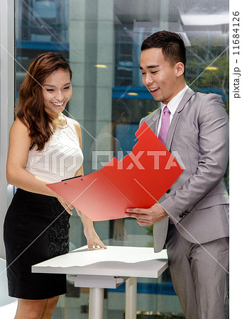 Young Asian business associates in discussion 11684126