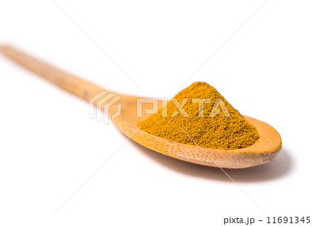 Milled curcuma on wooden spoon 11691345