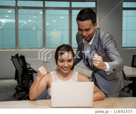 Young business associates celebrating achievement, success 11692355