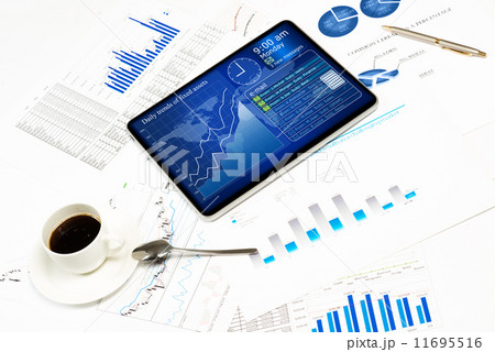 tablet, financial documents and a cup of coffee 11695516