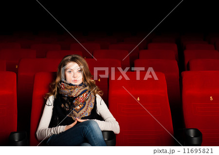 young attractive woman sitting in a cinema young attractive woman sitting in a cinema 11695821