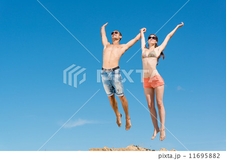 young couple jumping together young couple jumping together 11695882