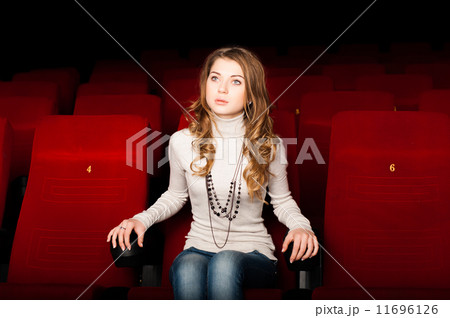 young attractive woman sitting in a cinema young attractive woman sitting in a cinema 11696126