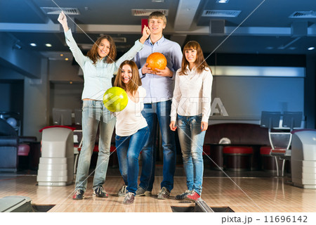 Group of young friends playing bowling 11696142