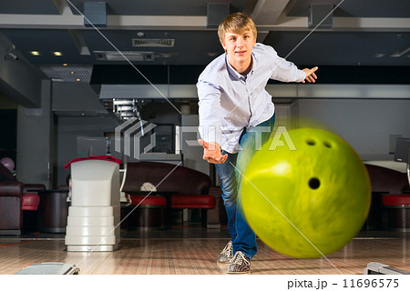 young man playing bowling young man playing bowling 11696575