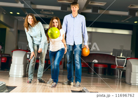 Group of young friends playing bowling 11696762