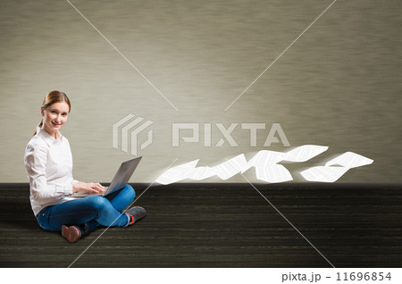 young girl sitting on the floor with a laptop young girl sitting on the floor with a laptop 11696854