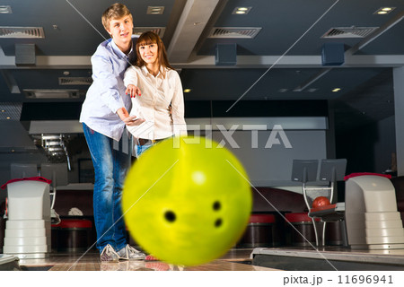 young couple plays bowling young couple plays bowling 11696941