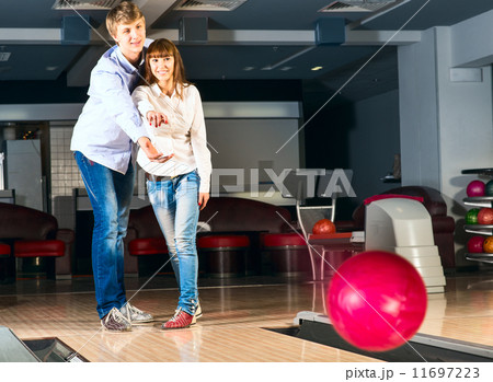 young couple plays bowling young couple plays bowling 11697223
