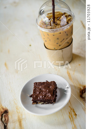 Fresh Homemade Chocolate Brownie and ice coffee against a backgr 11703928