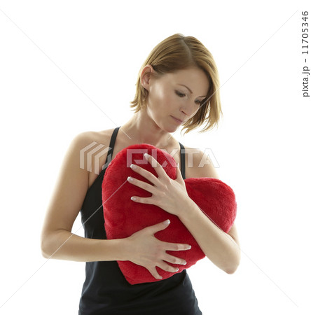 Woman with heart pillow Woman with heart pillow 11705346