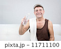 Adult Male Relaxes and Cools Down After Exercising with Water.. 11711100