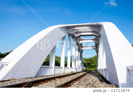 Old white railway bridge constructed against a blue sky in Lamphun, Thailand. Old white railway bridge constructed against a blue sky in Lamphun, Thailand. 11711674