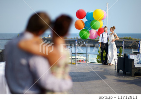 Happy bride and groom with balloons 11712911