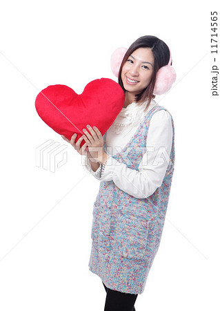 woman dressed in warm clothes with love pillow woman dressed in warm clothes with love pillow 11714565