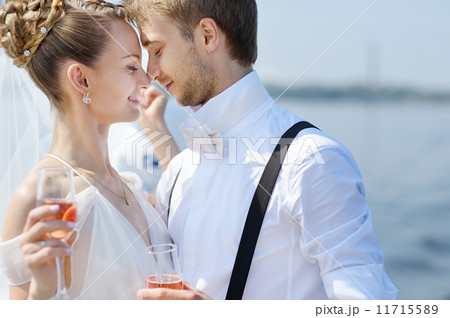 Happy bride and groom drinking champagne 11715589