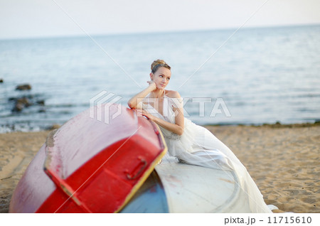 Beautiful bride sitting on a boat 11715610