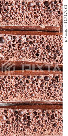 Background of porous milk, black chocolate 11717631