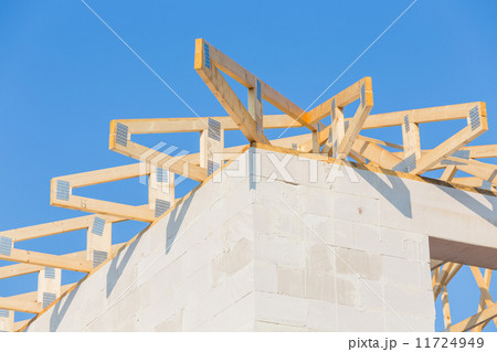 New residential construction home framing against a blue sky New residential construction home framing against a blue sky 11724949