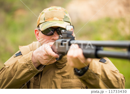 Man in camouflage with a shotgun 11733430