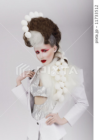 Haute Couture. Extravagant Woman in Cyber Costume and Theatrical Hair-do 11733512