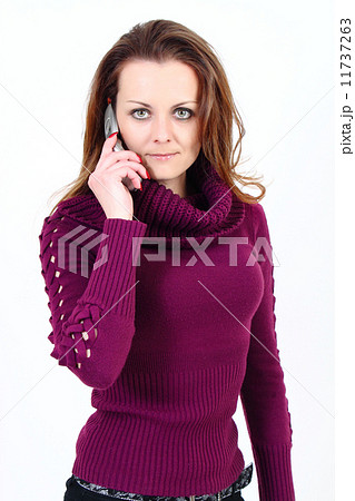 The attractive woman with pullower talks by a mobile phone on a white background The attractive woman with pullower talks by a mobile phone on a white background 11737263