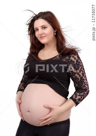 beautiful pregnant woman tenderly holding her tummy isolated on white background 11738077