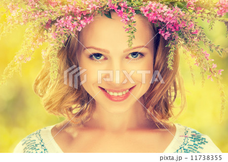 beautiful happy Slavic girl in a wreath of summer flowers 11738355